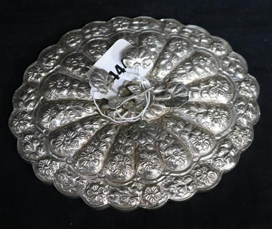 A 20th century Persian repousse white metal cusped oval mirror, 8in.